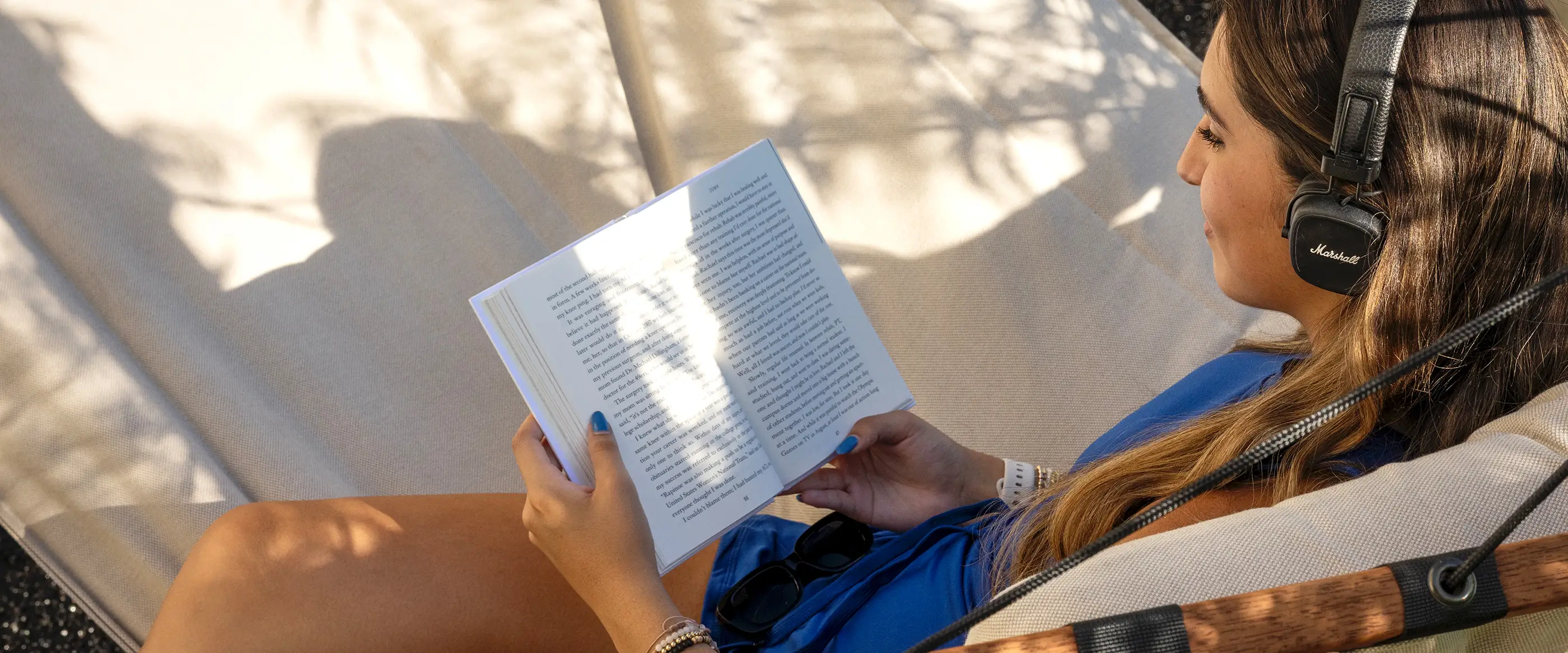 a woman reading a book outside